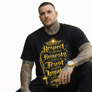 Male-model-wearing-black-Respect-Is-Earned-streetwear-t-shirt-with-gold-graphic-design-by-Merch-By-Mike-on-white-background